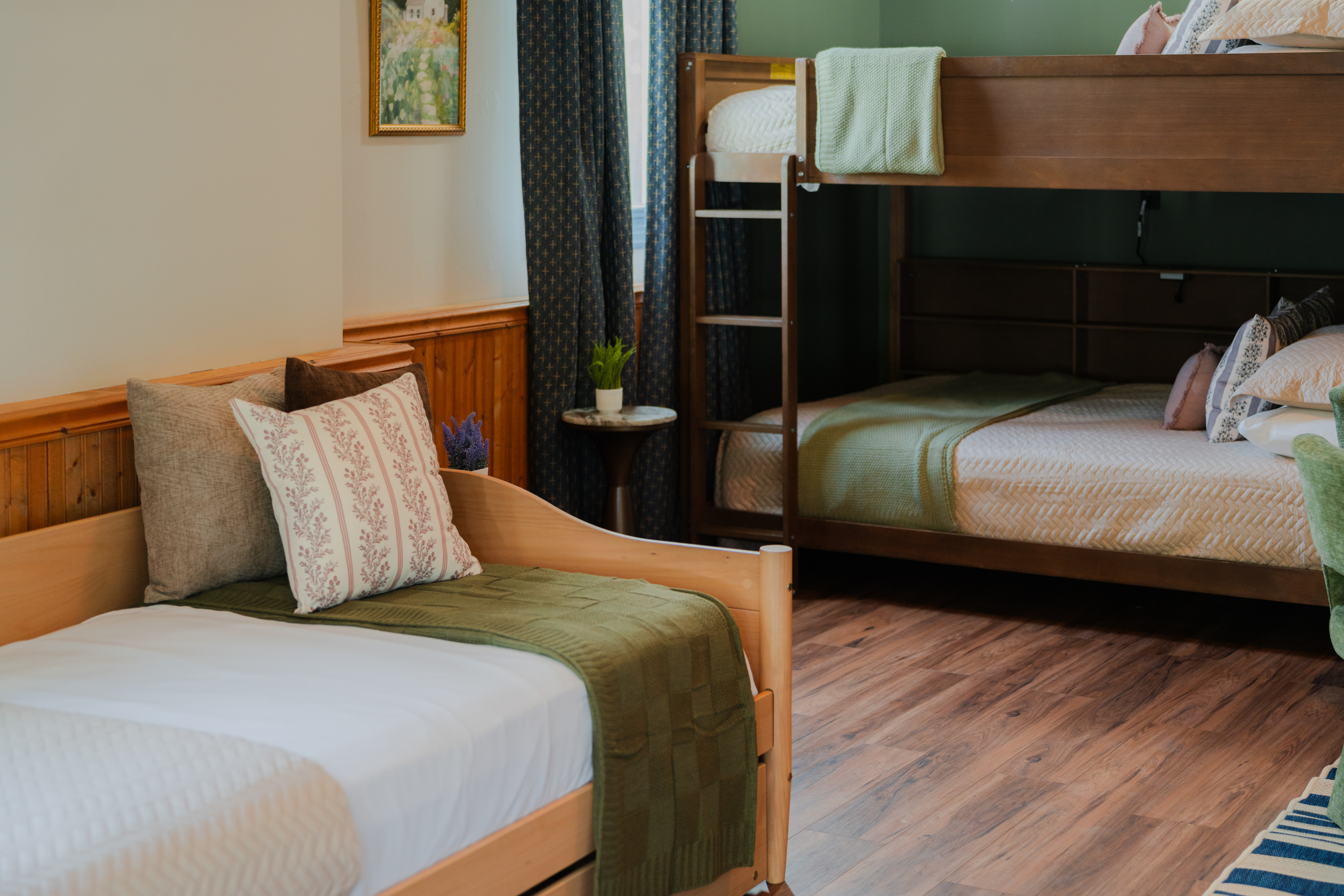 Queen-over-queen bunk bed plus a twin bed for flexible sleeping arrangements.