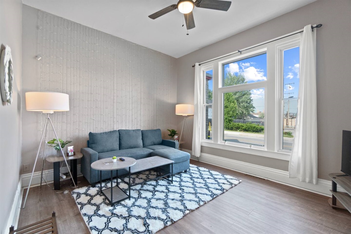Our cozy L-shaped sofa doubles as a comfortable sleeping spot for a third guest."
