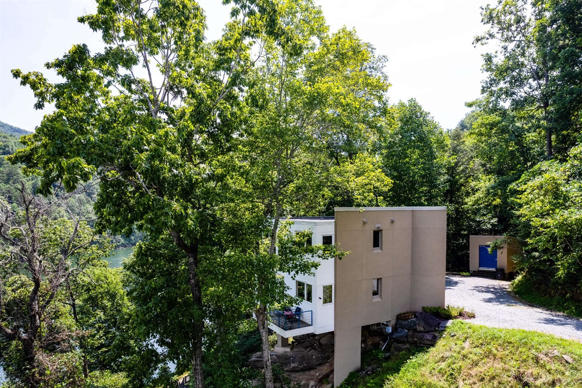 The side view of the home as you come down the gravel driveway