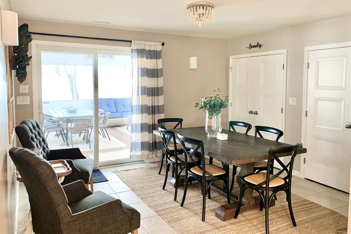 Enjoy family meals at our farmhouse-style dining table with seating for six. This bright space features stylish cross-back chairs, additional fireside seating, and sliding glass door access to the sunroom for an indoor-outdoor flow.