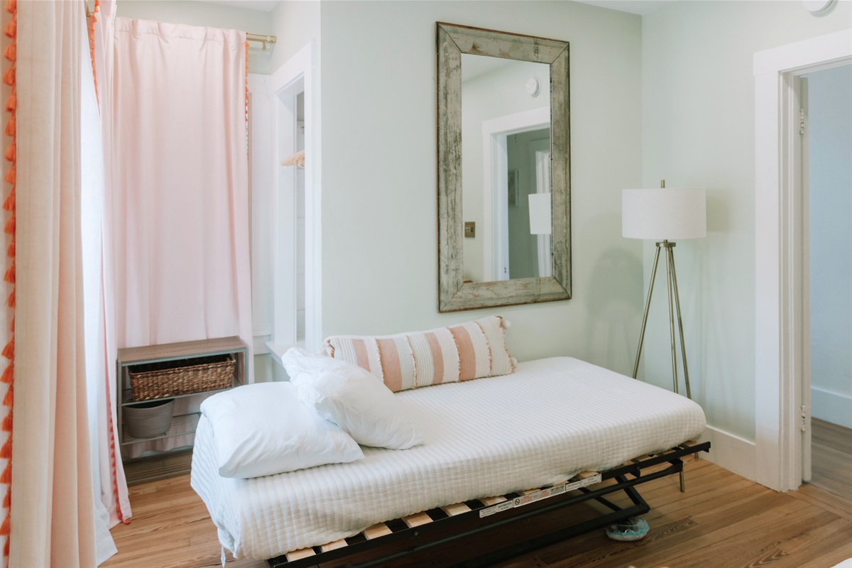 The third bedroom has a daybed and a pullout bed, garnished with colorful art throughout.