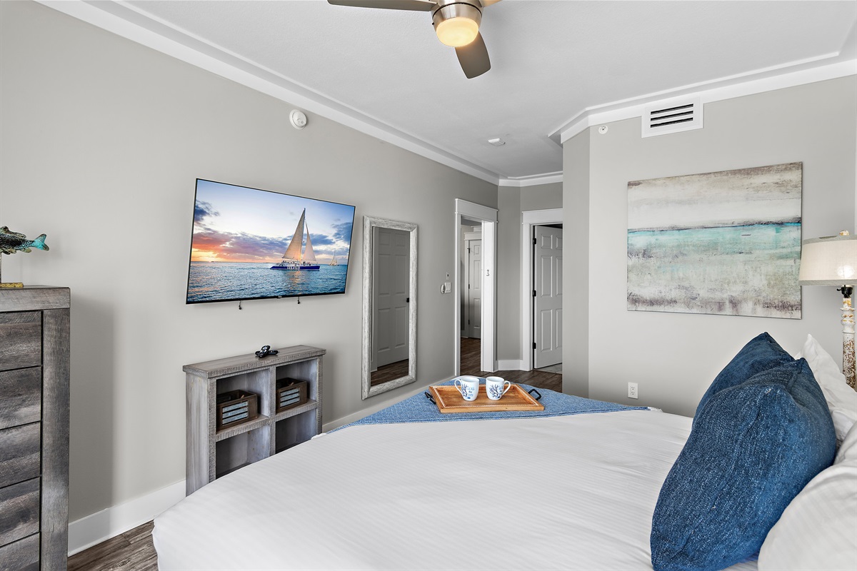 Primary Bedroom is spacious with a King bed, Smart TV, large closet, and attached bathroom with remodeled, walk in shower.