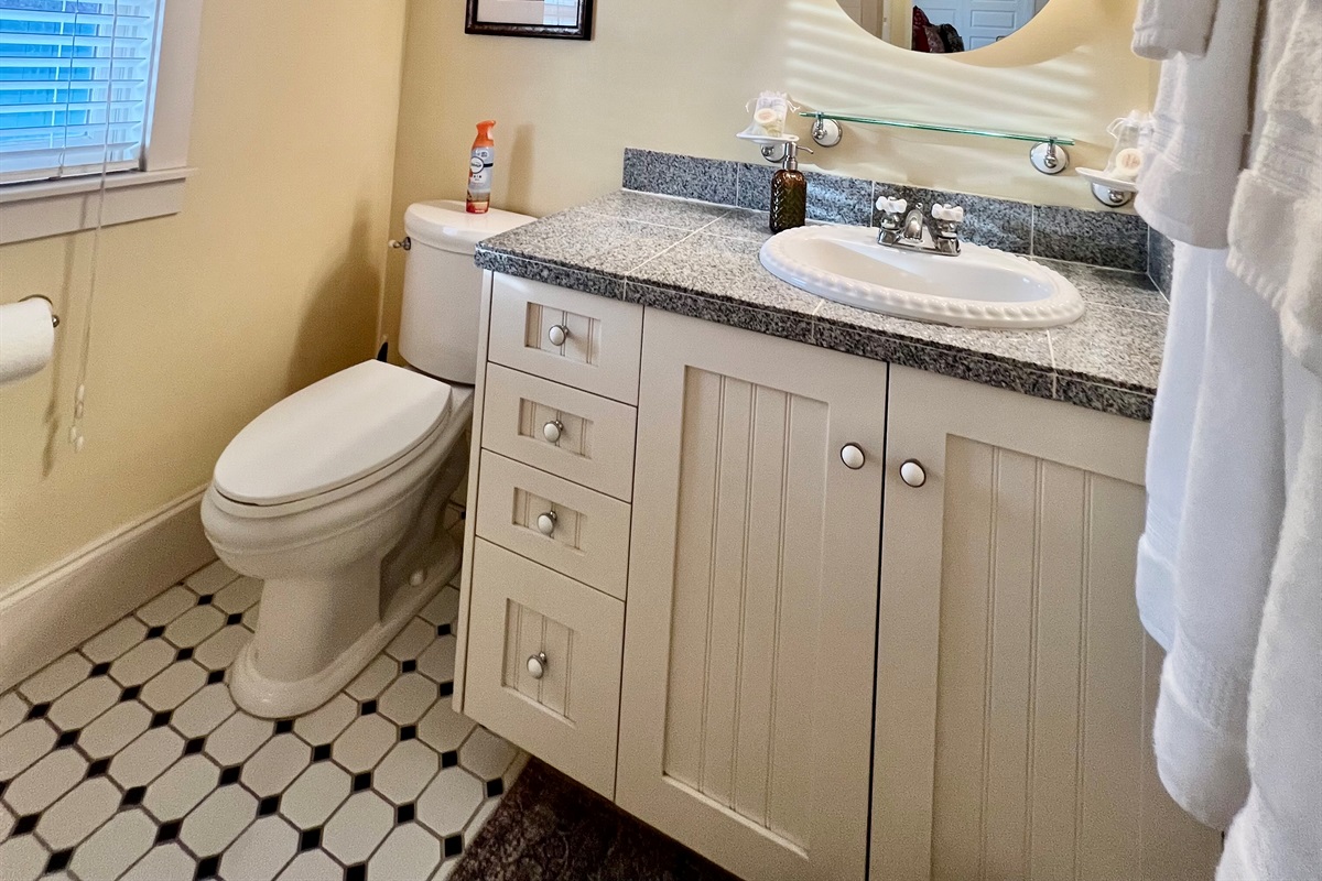 The bathroom is charming and provides privacy with plenty of natural light.