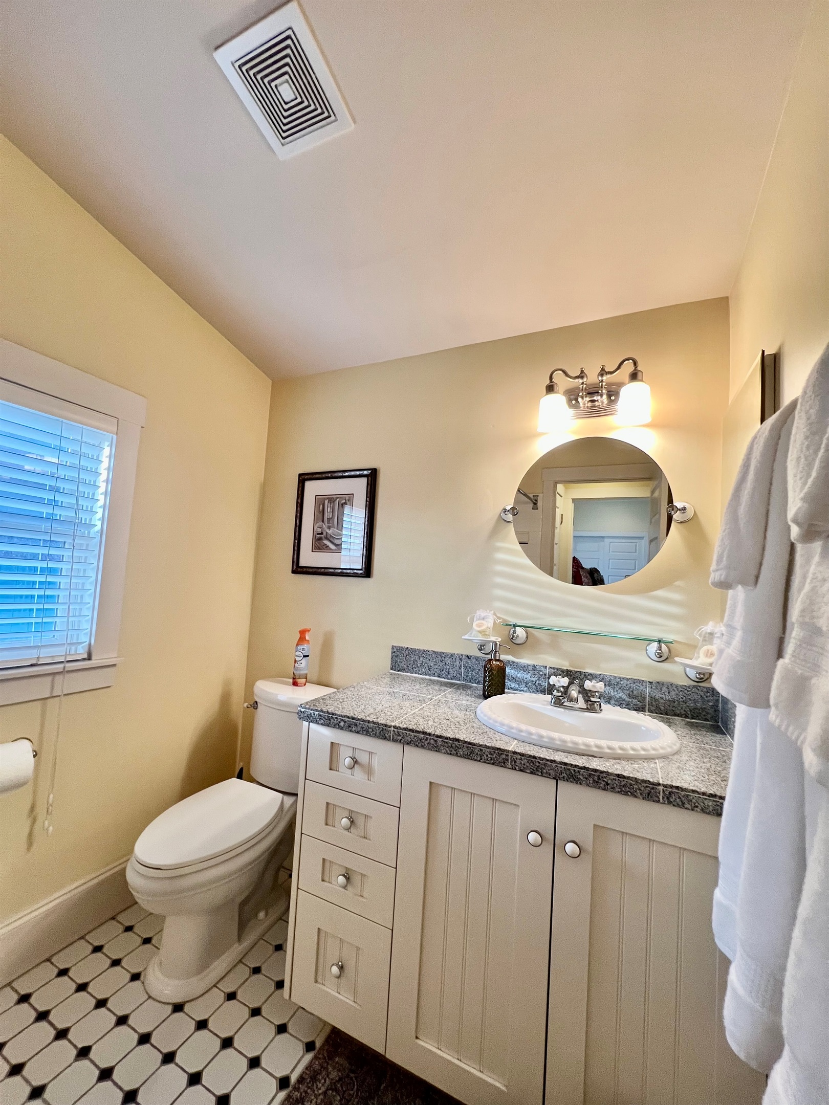 The bathroom is charming and provides privacy with plenty of natural light.