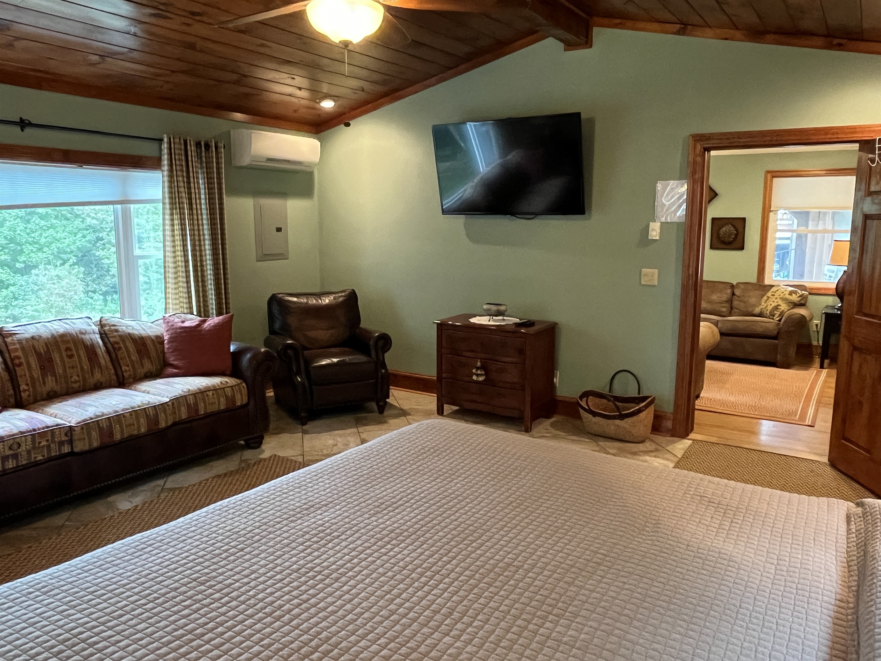 Kimg primary bedroom with living room beyond