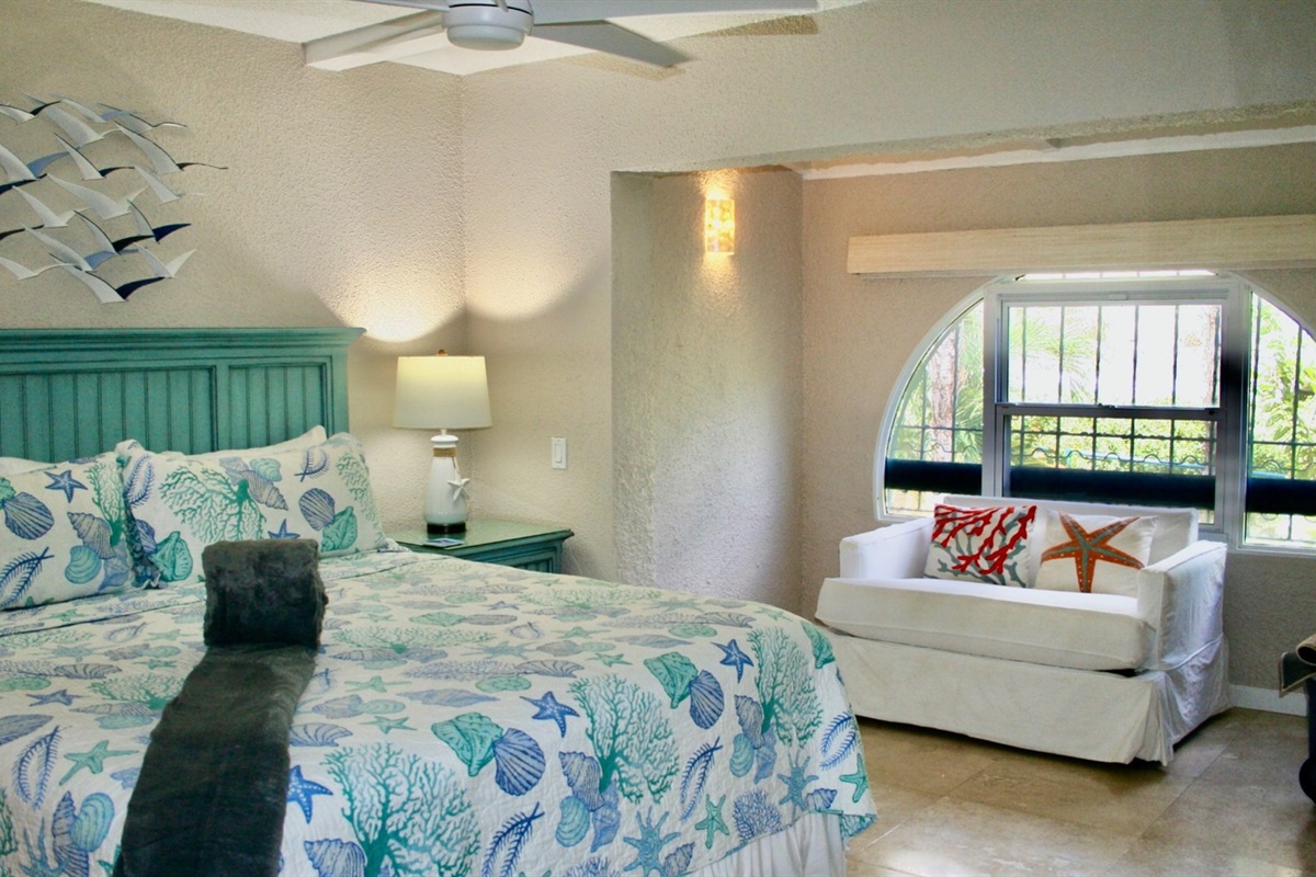 Suite two with king bed and community garden view. 