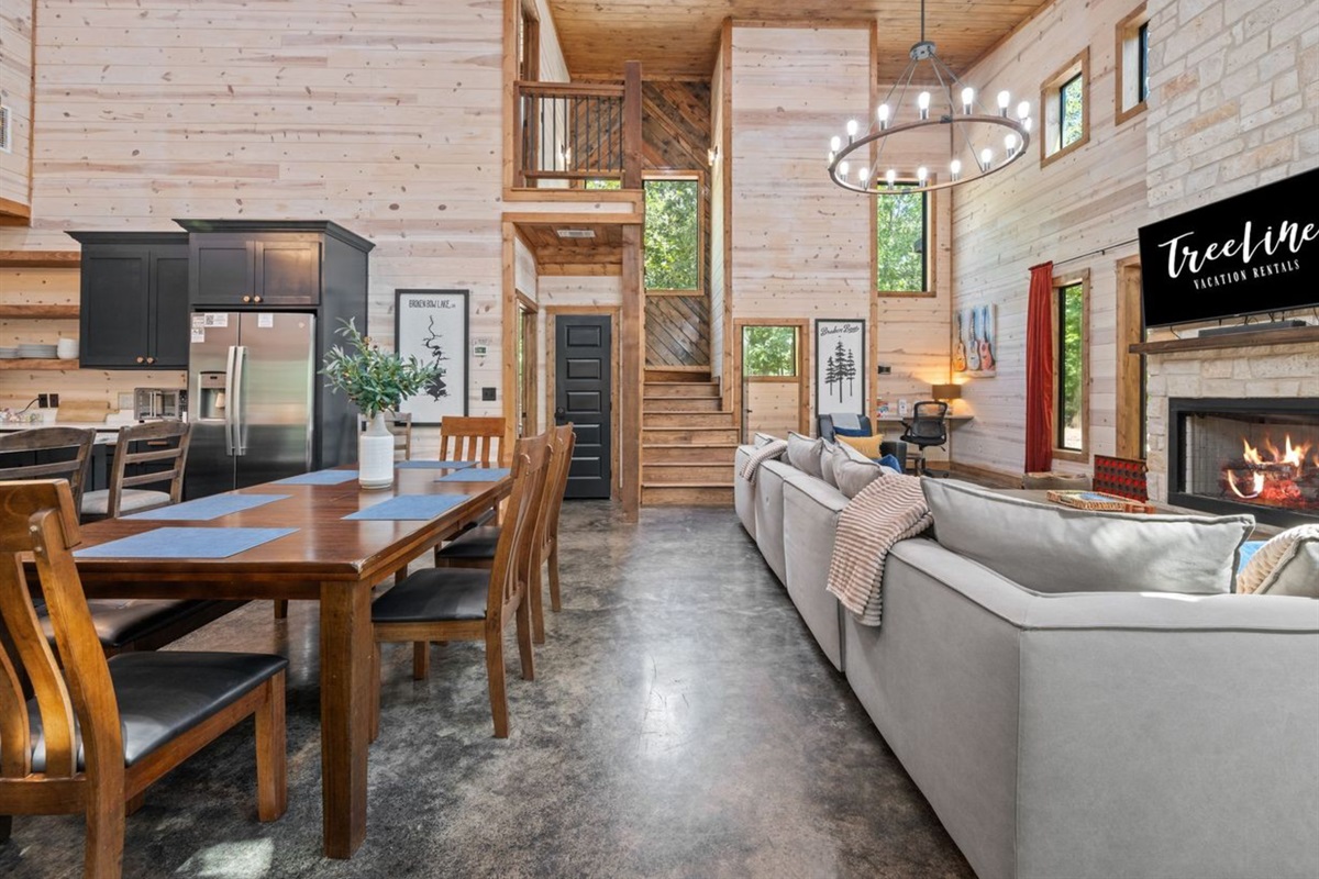 Stylish living room with vaulted ceilings, sectional seating, and abundant natural light.