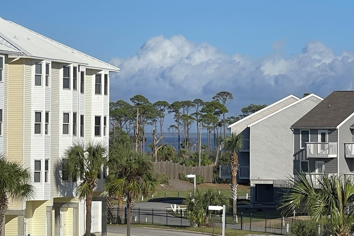 Sit out here and watch the still water. Your private St. Joe Bay balcony faces a completely different kind of beautiful than the Gulf side.