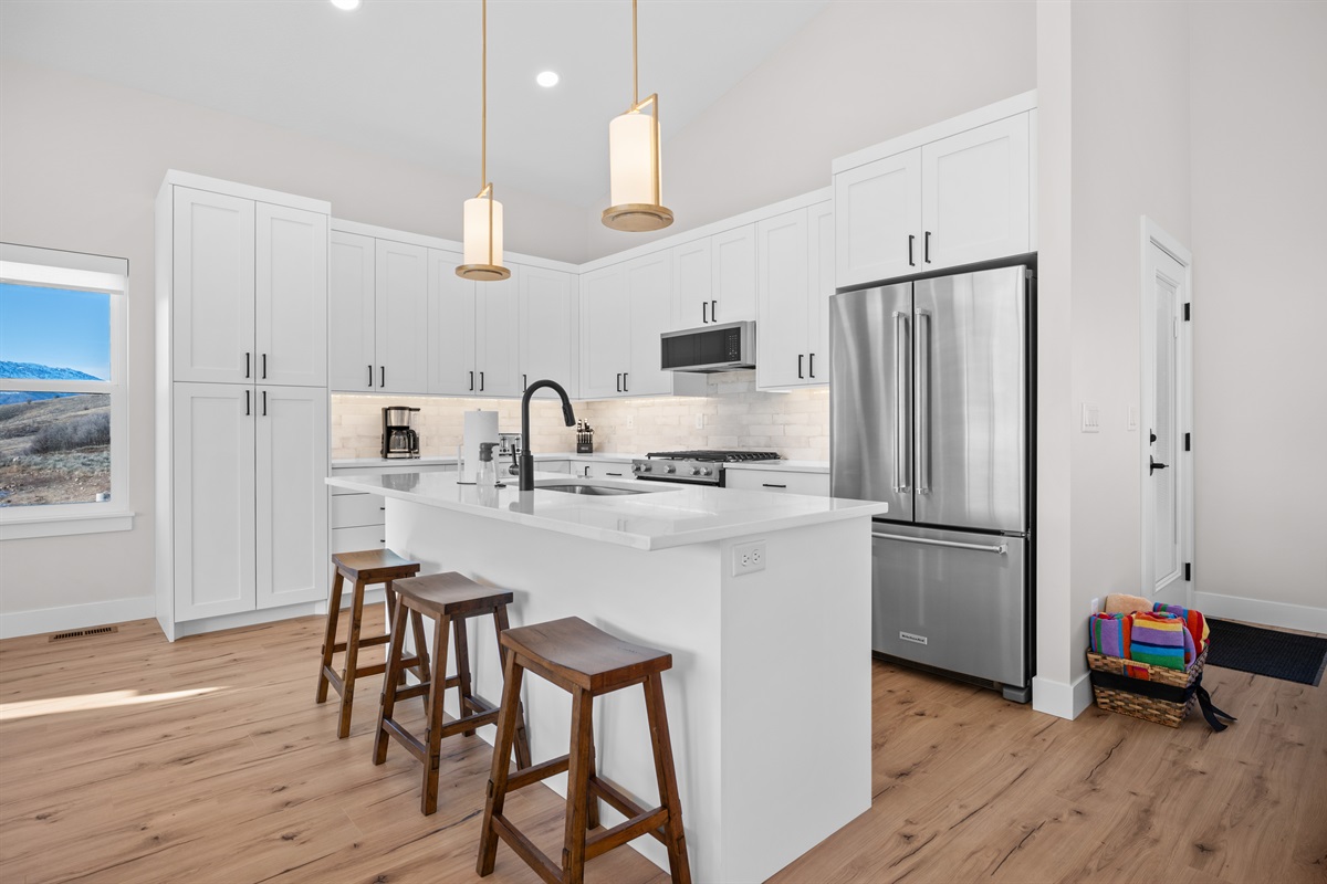 Open dining and kitchen layout with island seating — ideal for gathering with family and friends.