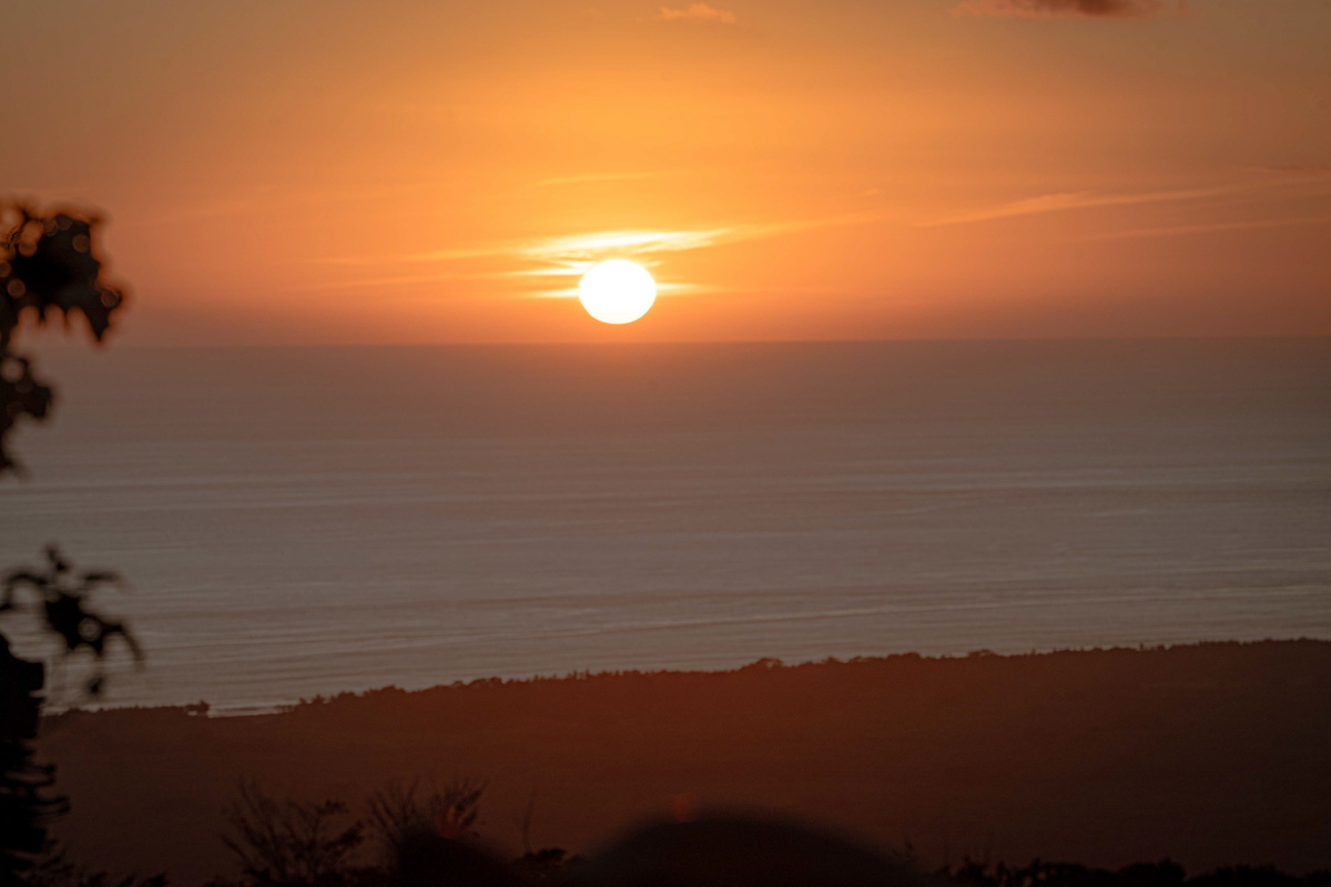 Golden Pacific sunset stretching across the horizon from Casa Infinity