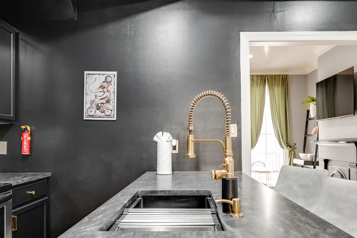 Chic Kitchen: Experience culinary adventures with stylish decor and modern, golden fixtures!