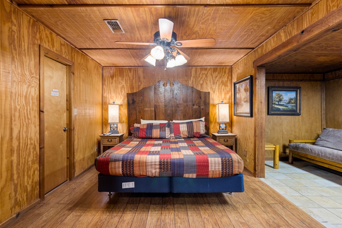 Spacious bedroom with cozy bedding and ceiling fan.