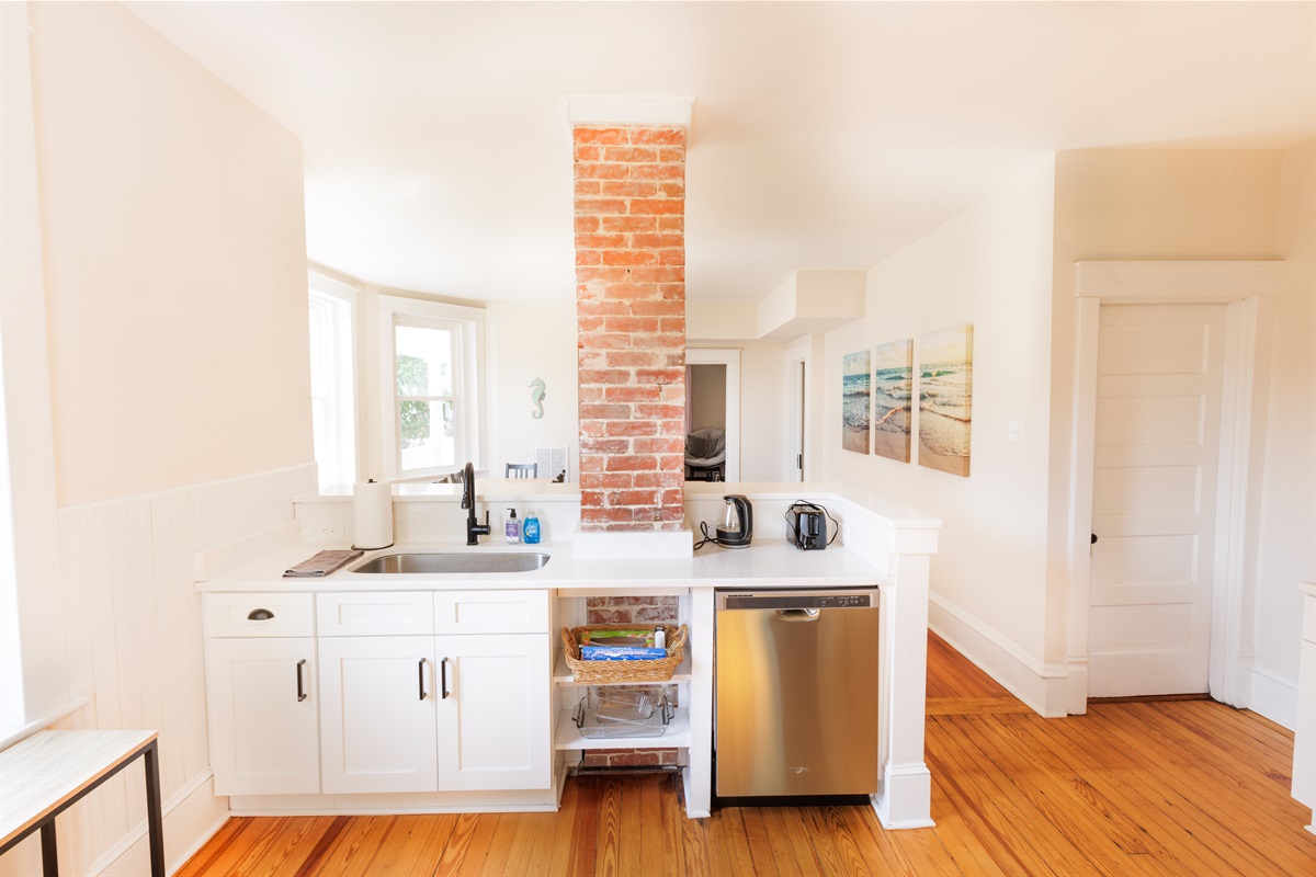 Kitchen with cooking essentials and modern appliances.