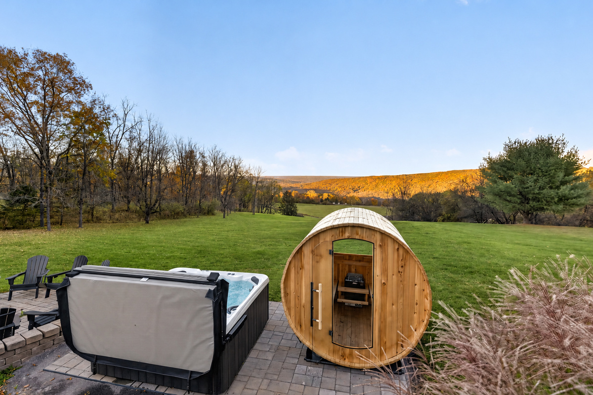 Hot tub and sauna overlooking the grassy lawn