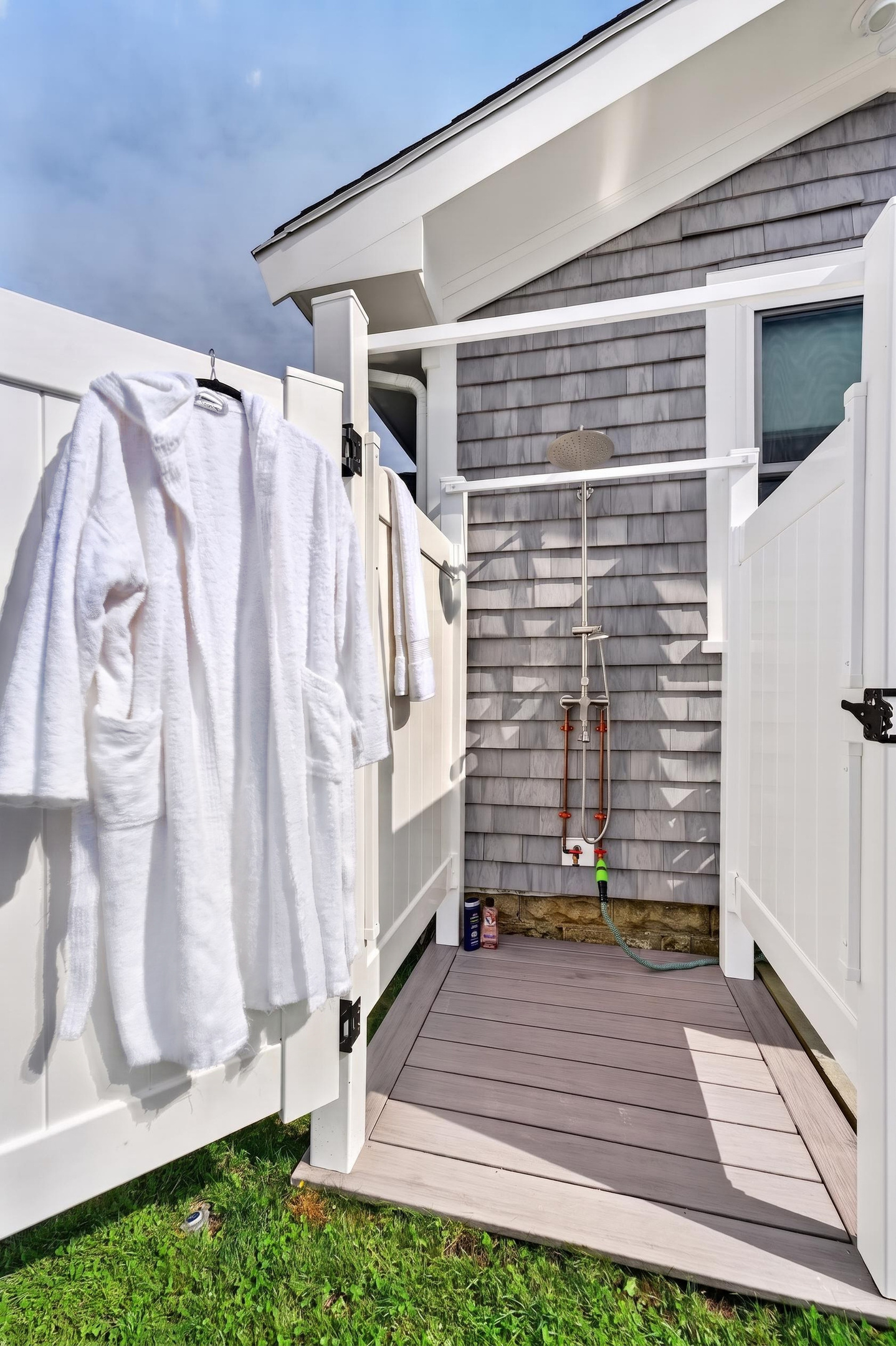 Convenient outdoor shower area with fresh bathrobes ready for your stay.