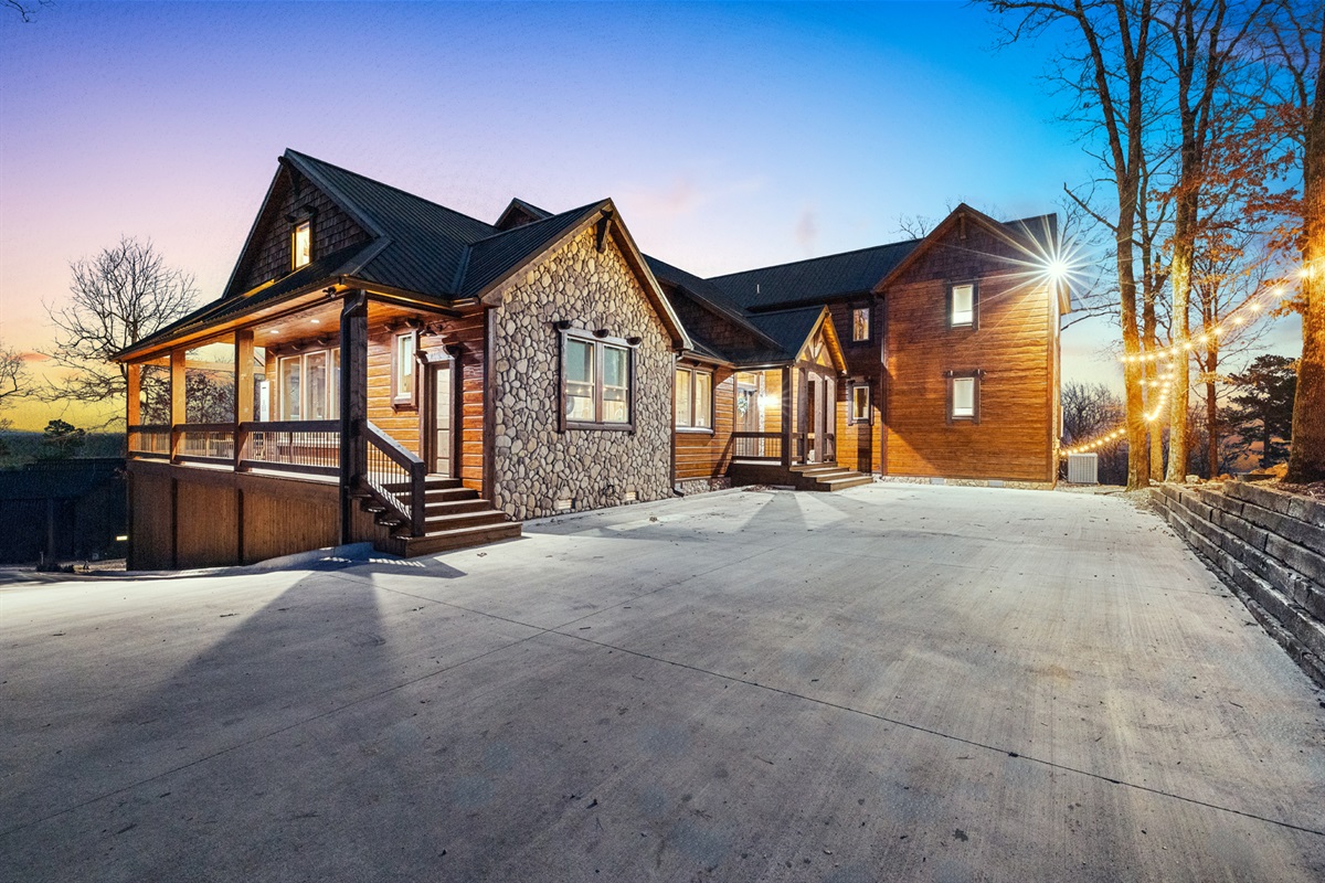Stunning luxury cabin exterior with warm evening charm and rustic elegance
