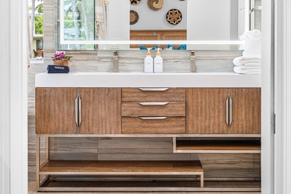 Sleek and spa-inspired, this double vanity features warm wood tones, clean lines, and a statement mirror for a polished, modern look.