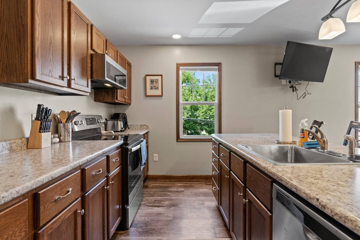 Fully equipped kitchen with a spacious countertop and ample cabinets, providing plenty of storage and space for all your cooking needs.