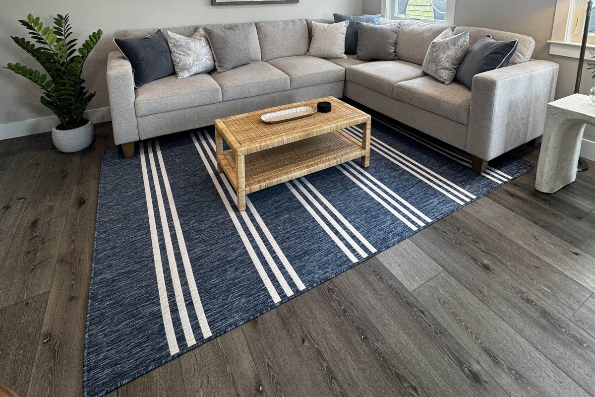 Bright and comfortable living room with a spacious sectional sofa, natural light, and a cozy coffee table setup—perfect for relaxing and spending time indoors.