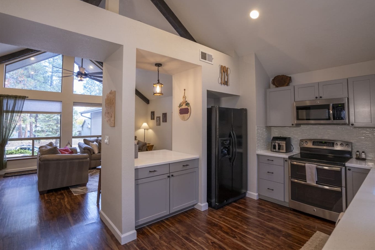 Kitchen view with full-size appliances, extra counter space, and open access to the living area.