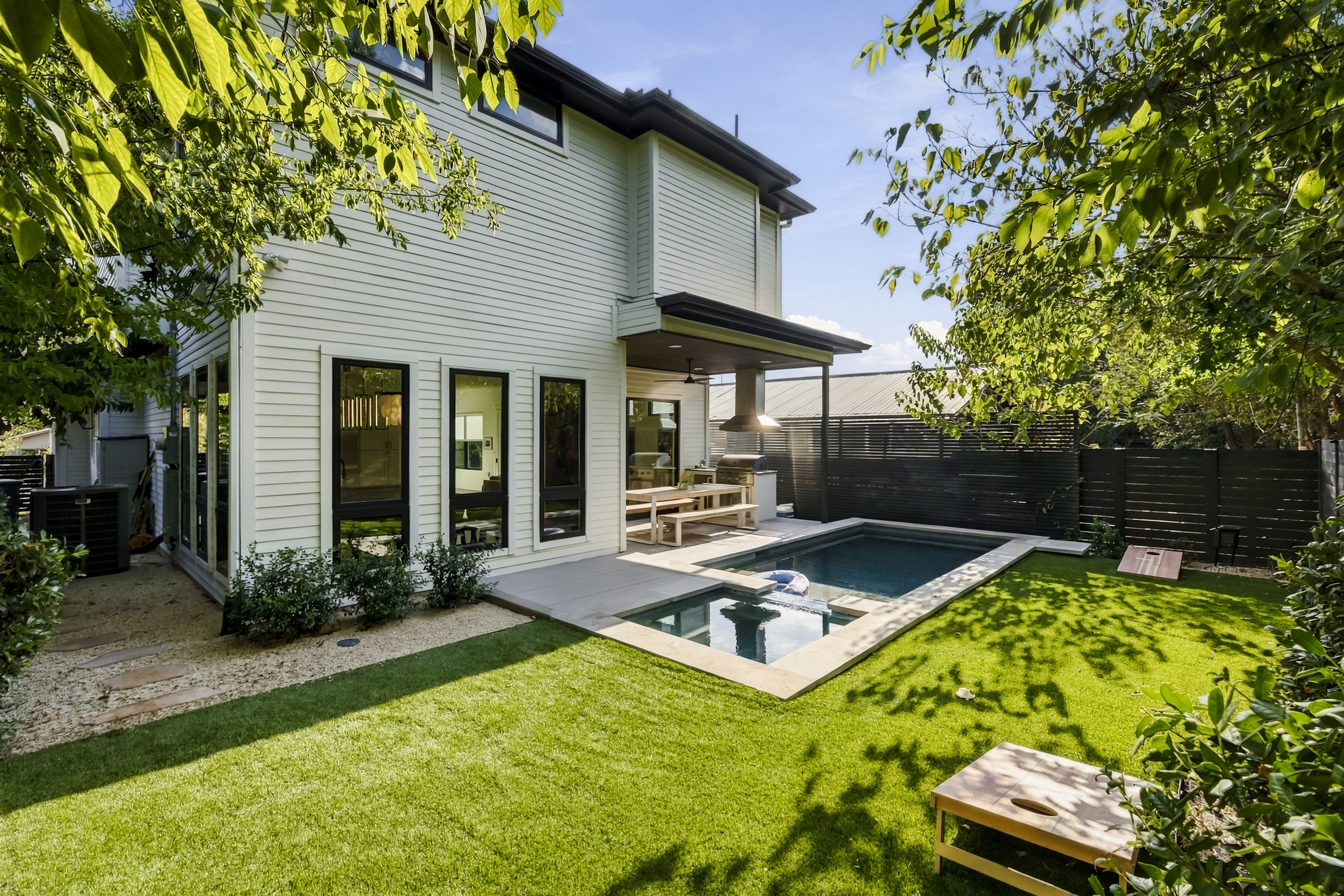 A turf backyard and sleek pool make this East Austin home an entertainer's dream.