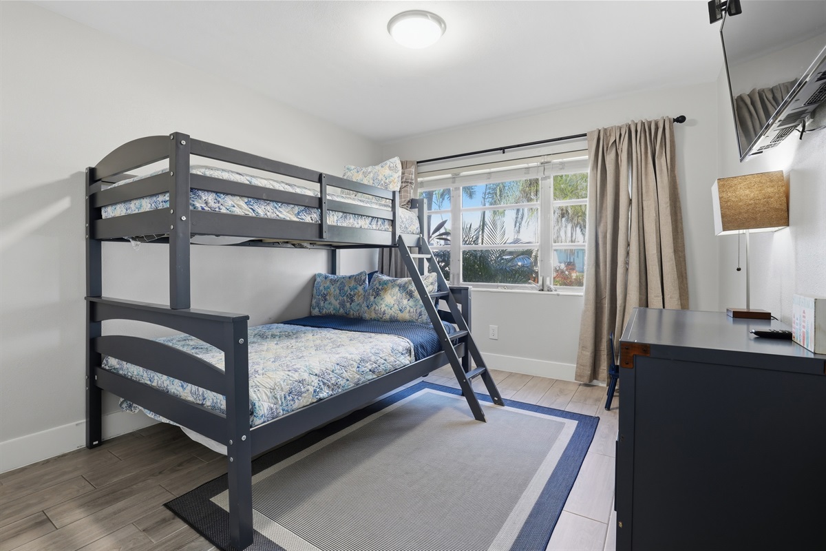 Guest bedroom 2 with twin over full bunkbed, dresser and TV