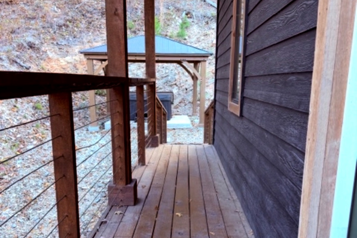 Your private escape continues outdoors — stroll to the hot tub tucked beneath the trees