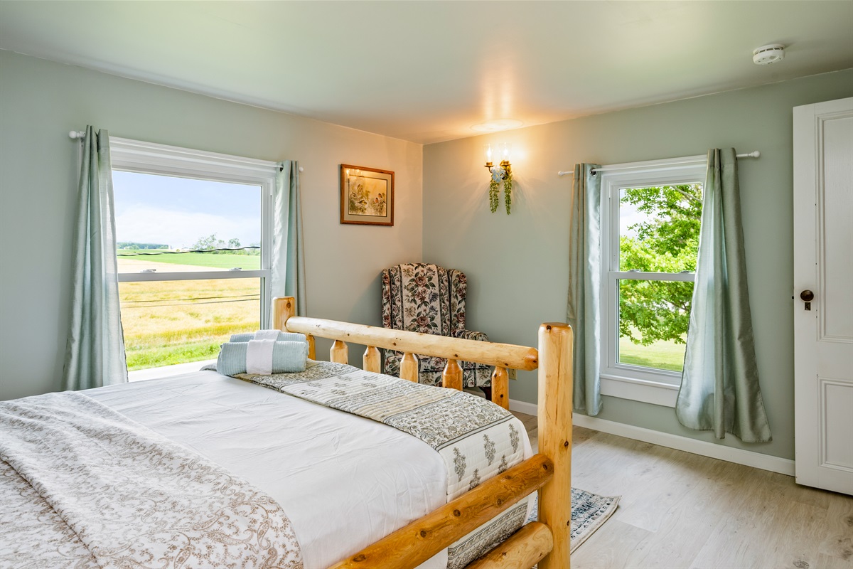 Relax in this beautifully furnished log-frame bed with peaceful views and cozy cottage charm.