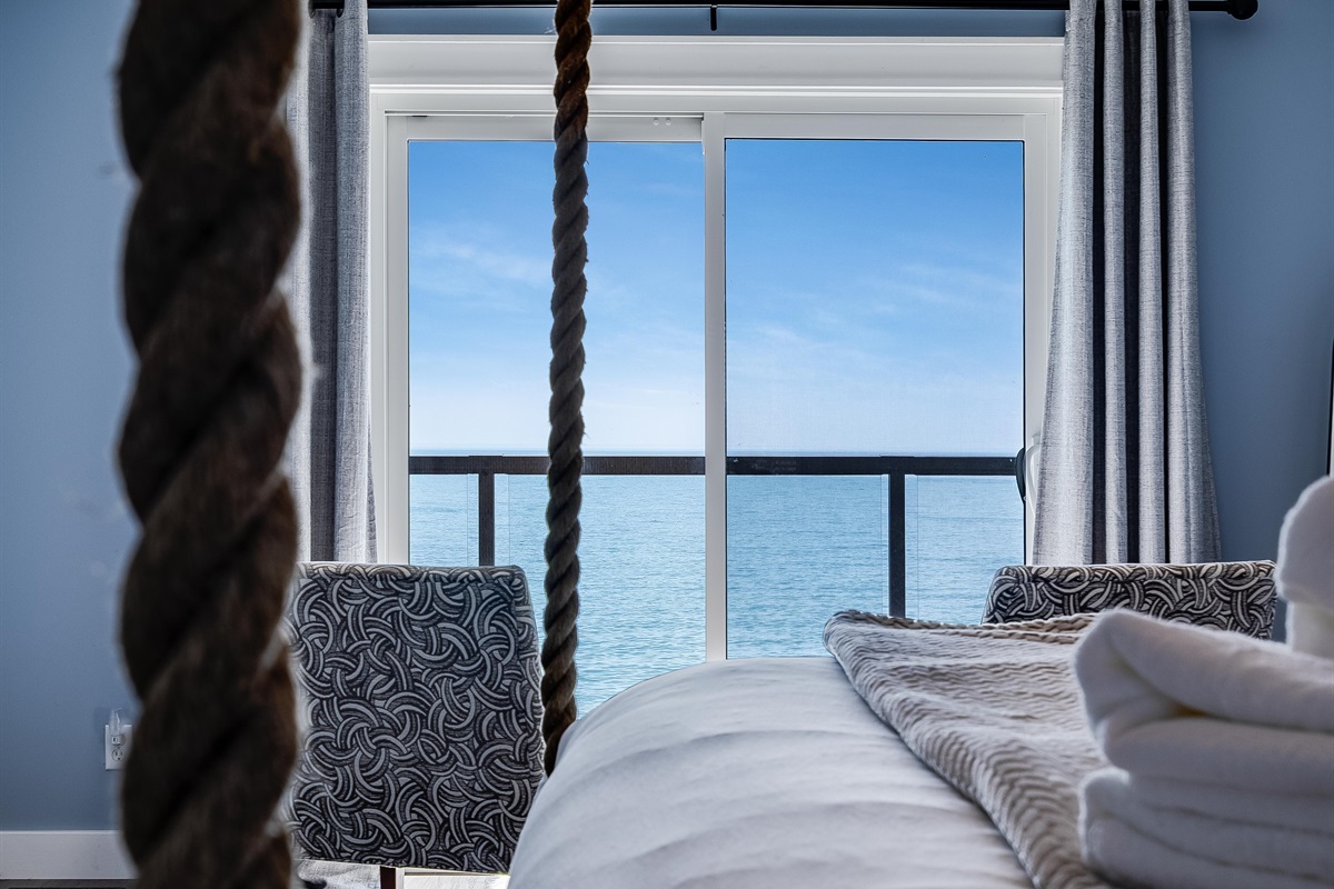 Master Bedroom with King bed and access to second story balcony with calming lake views