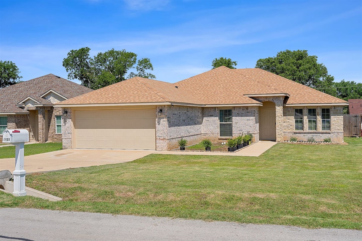 Explore a charming single-story home with a neat front yard and welcoming facade.