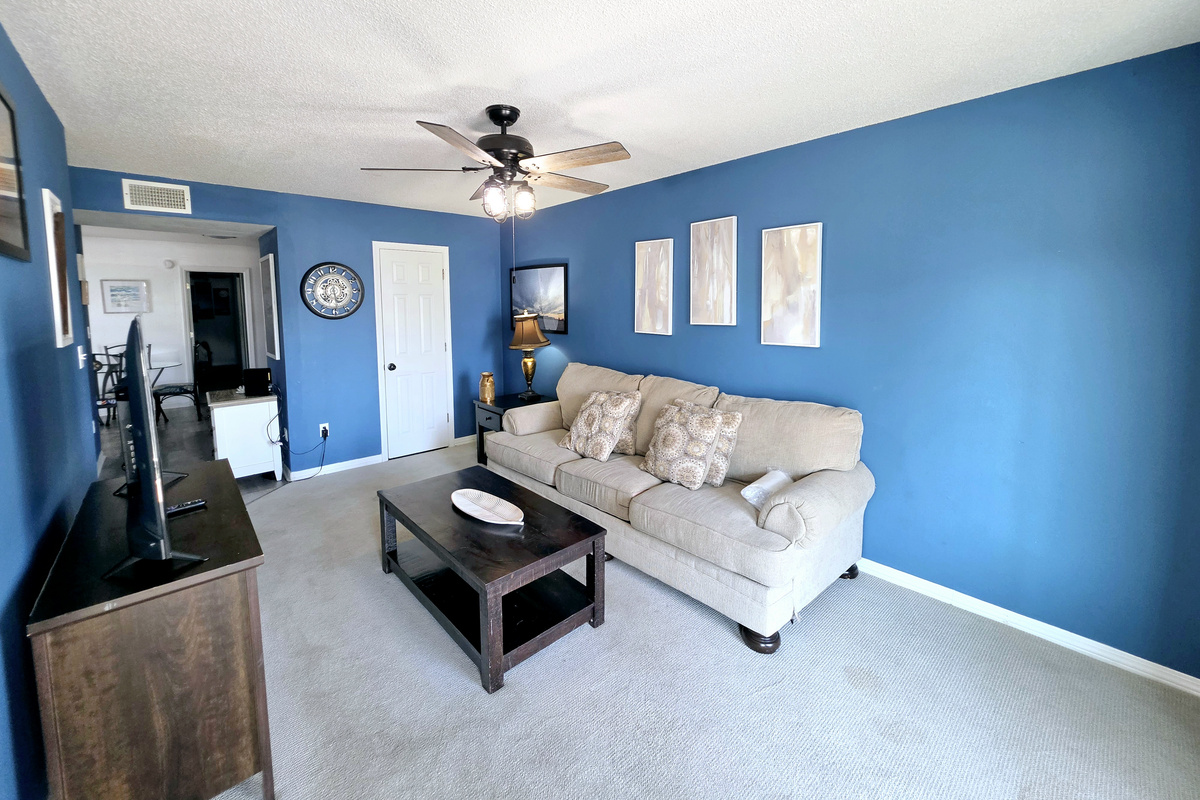 Living room with comfortable seating and ceiling fan