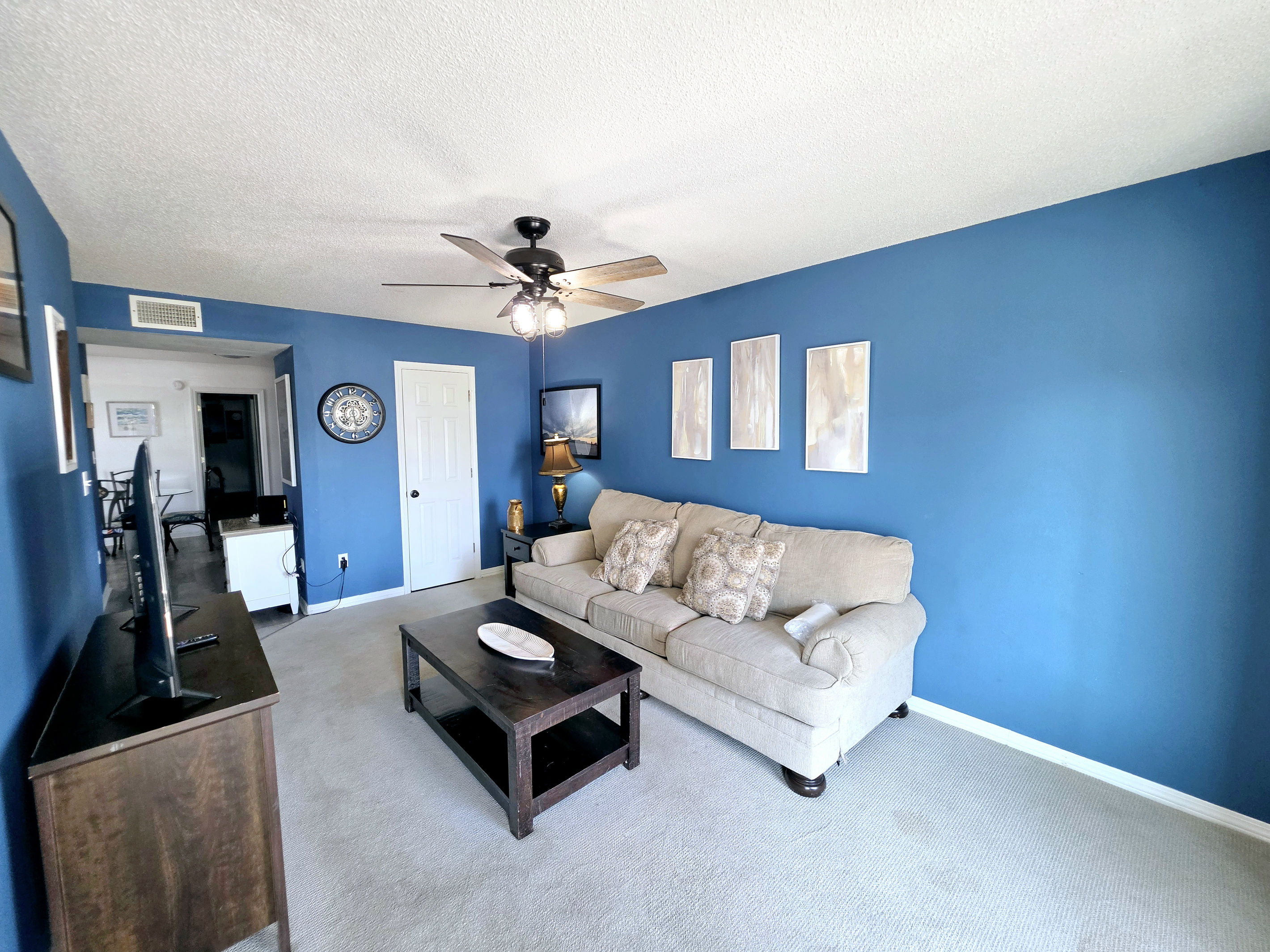 Living room with comfortable seating and ceiling fan