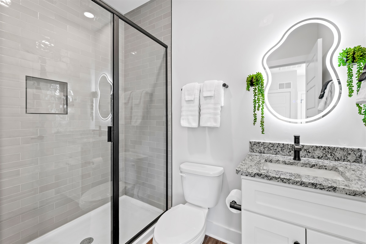 Full modern bathroom with a stand-up shower.