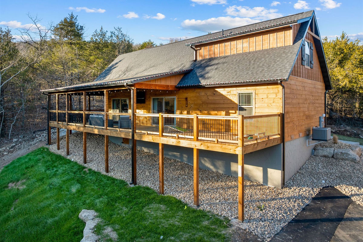 Daytime view of the cabin and its wraparound deck.