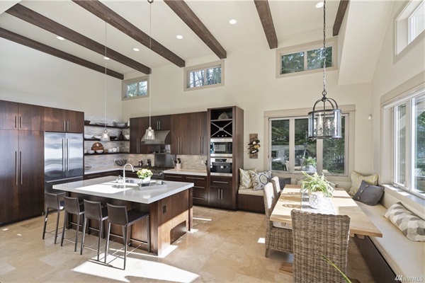 Spacious dining area and kitchen with island seating for four and a dining table for ten.