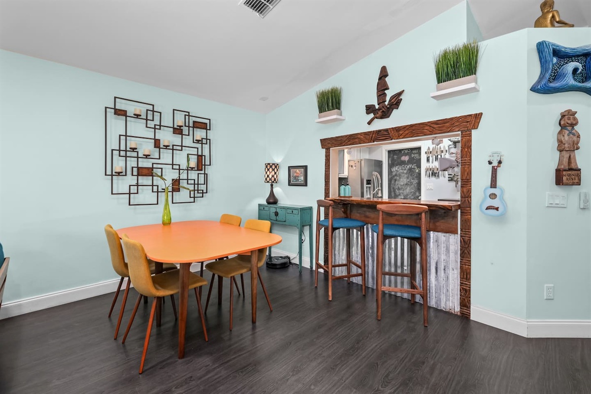 There is a dining table and bar area