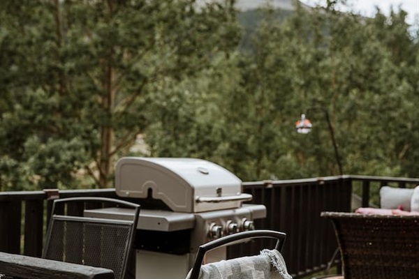 Grill, an outdoor table, gas fire table, sofa and views of the surrounding mountains and river. 