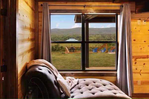 Primary bedroom chaise lounge with direct views of the deck and valley.