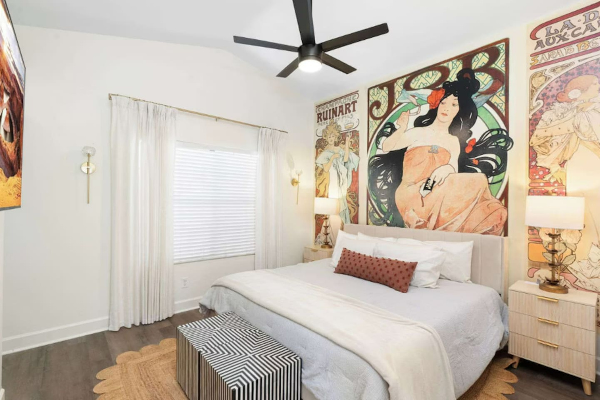 Curated primary bedroom with vintage art, soft linens, and warm lighting — a retreat within the retreat.