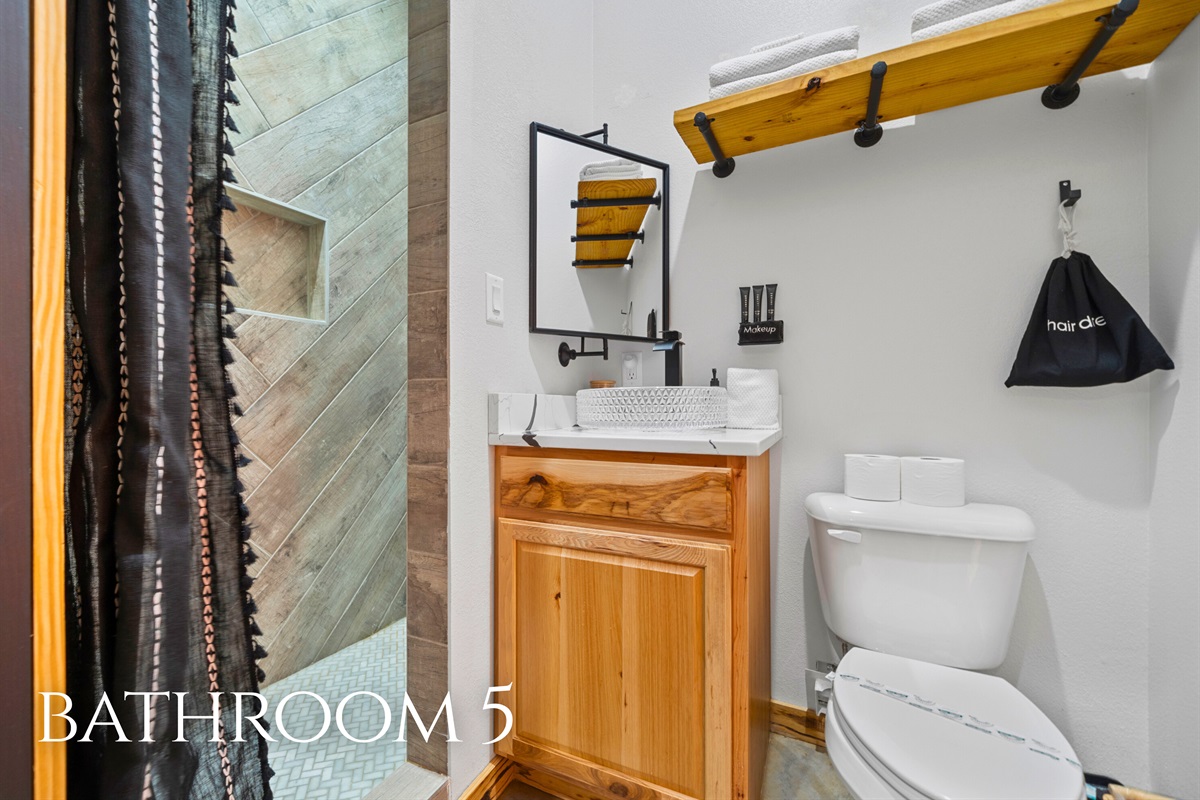 Bathroom 5 features a clean, modern design and a spacious shower, offering both comfort and functionality.