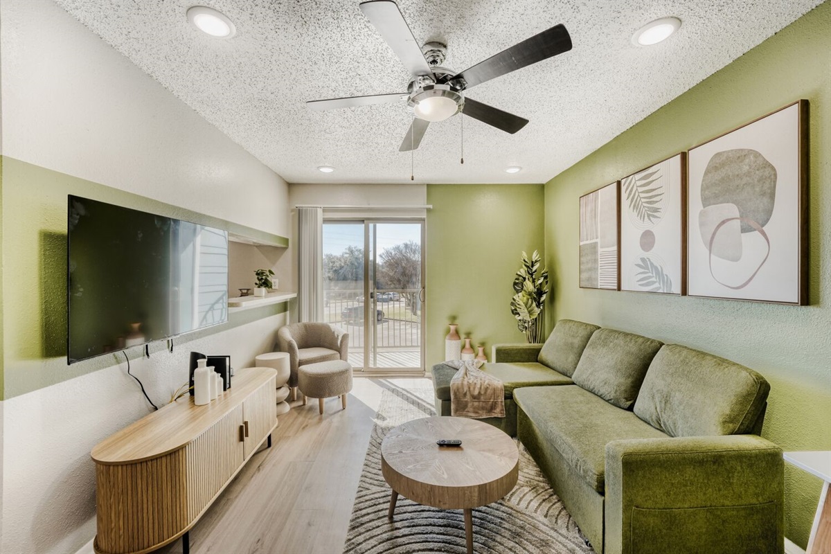 Bright modern living room with green accents and a cozy, inviting atmosphere.