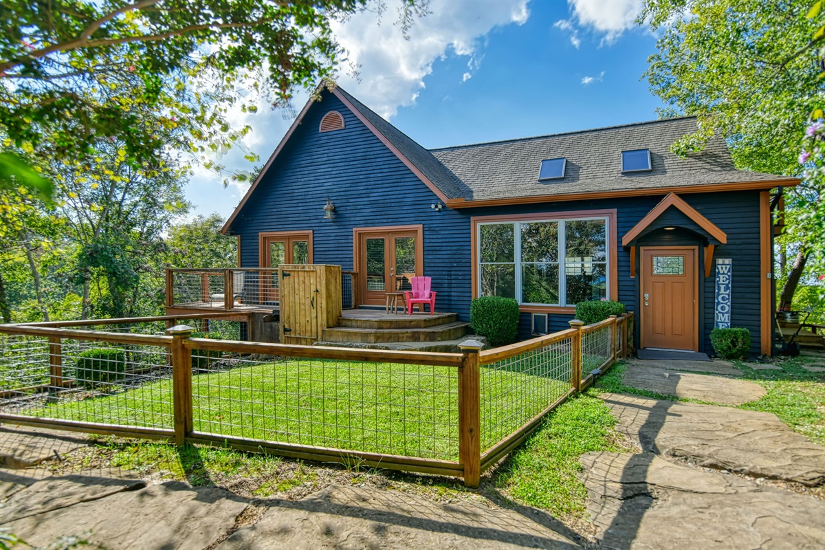 Fenced in yard with doggy door for furry friends 