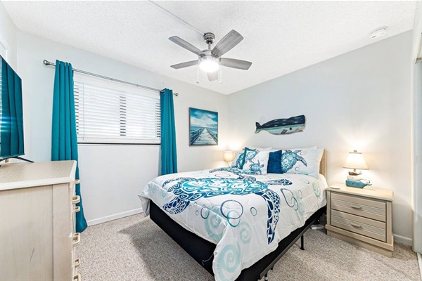 Second bedroom with queen sized bed, smart TV and closet