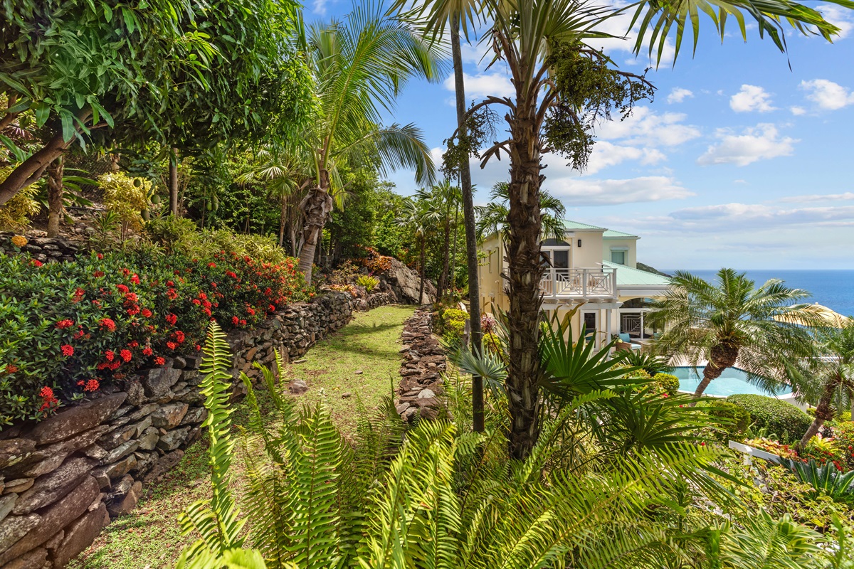 Tropical landscaping, lush plants, and walkways that make even coming home feel like a vacation.
