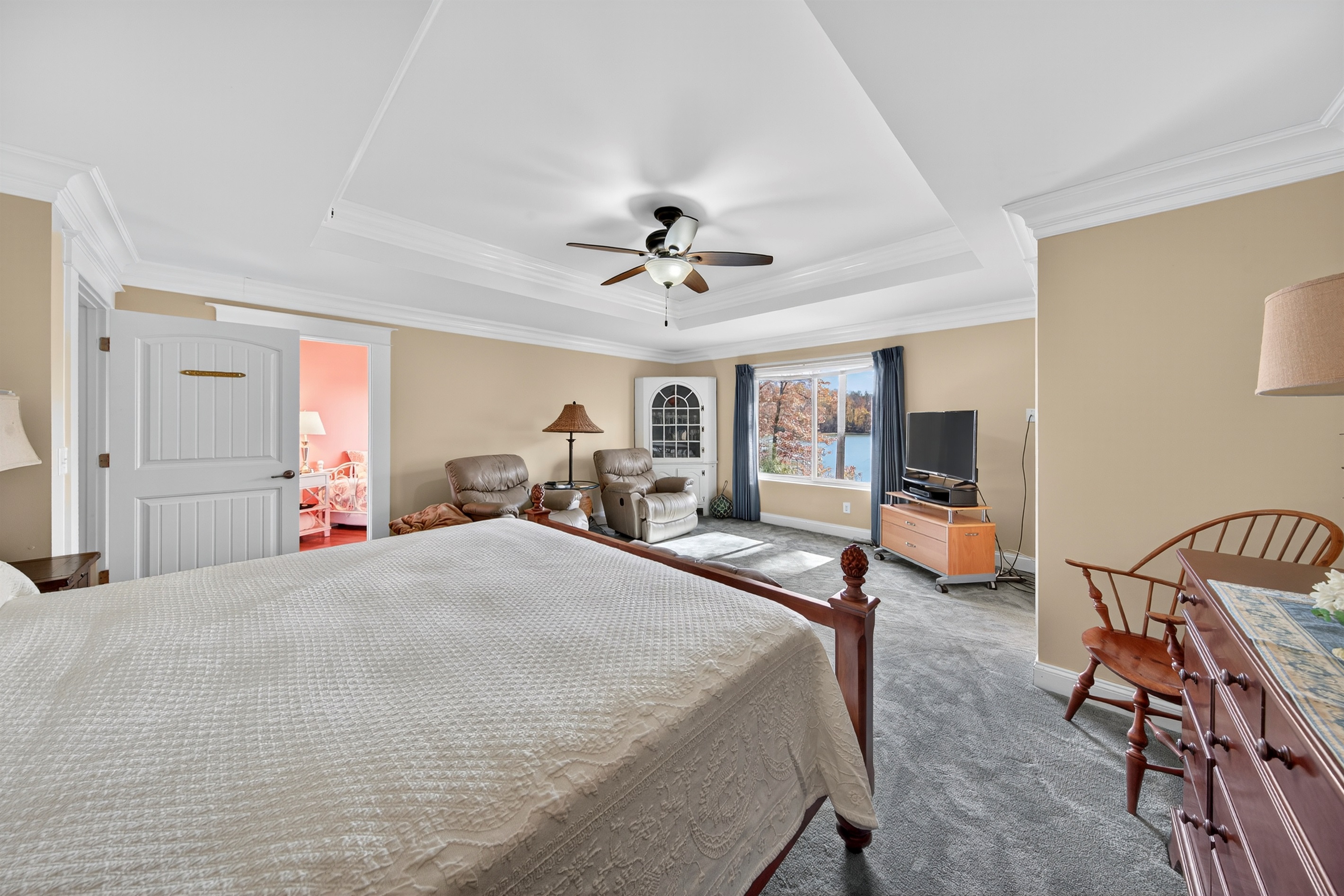 Cozy sitting area with big windows overlooking the trees and lake.
