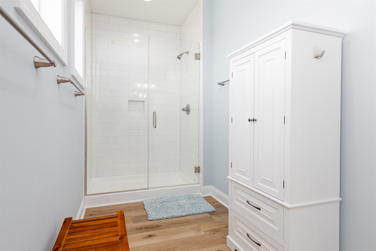 Master bathroom features a spacious glass-enclosed shower