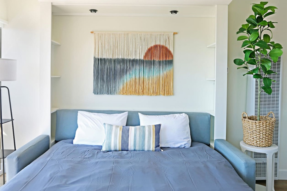 Here is a picture of the king-sized sofa murphy bed expanded. This bed is every bit as comfortable as a traditional bed with a premium mattress. This King murphy bed and sleeper ottoman enables this studio to accommodate up to 3 people comfortably.