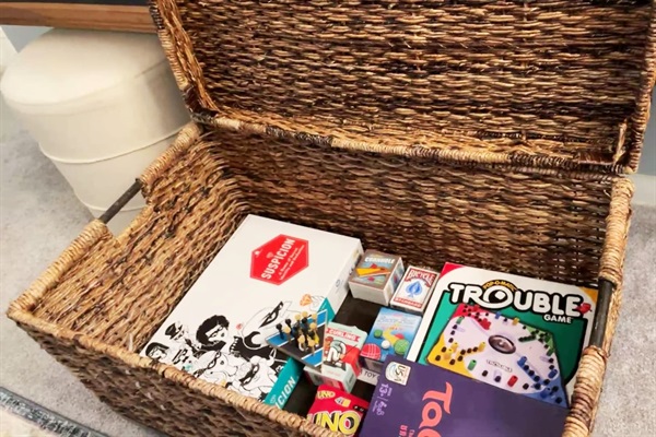 BOX OF GAMES in the Living Area (Currently, this box contains board games, (Trouble, Taboo, Suspicion), cards (Uno and Bicycle Brand playing cards and Uno) along with a mini peg game, mini Bing Bag toss, and more.  