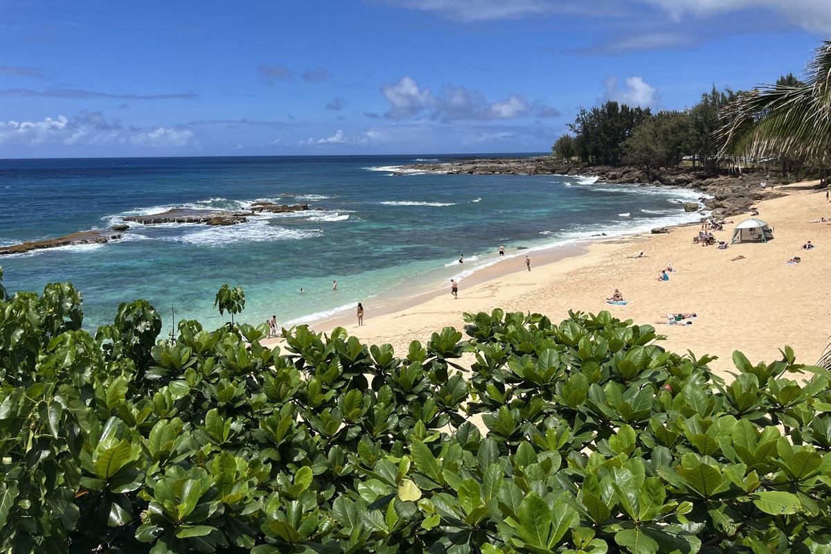 View of the white sands and turquoise waters of Three Tables Beach from the deck