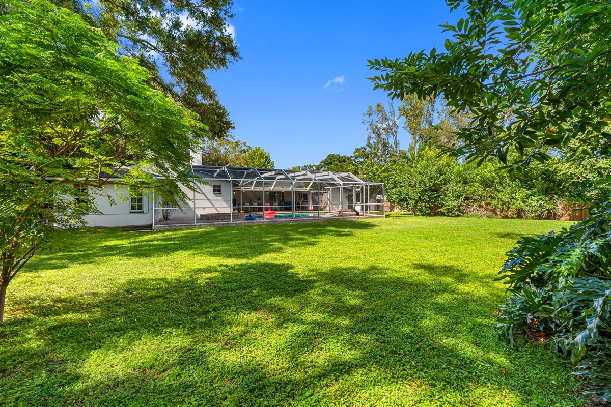 Enjoy the best of indoor-outdoor living with a vast backyard that flows seamlessly from the screened-in pool area.